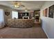 Living room with plush carpeting, a sectional sofa, and a view into the kitchen at 1517 N E St, Elwood, IN 46036