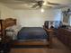Main bedroom featuring wooden bed frame with a dark comforter and matching wooden dressers at 1517 N E St, Elwood, IN 46036