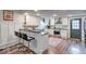 Modern white kitchen with stainless steel appliances and a farmhouse sink at 1626 S Delaware St, Indianapolis, IN 46225