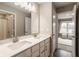 Modern bathroom with double vanity and view into bedroom at 17259 Carlton Rd, Westfield, IN 46074