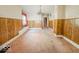 Dining room with wood paneling, chandelier, and pink carpet at 2118 N Dexter St, Indianapolis, IN 46202