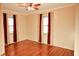 Hardwood floor bedroom with two windows and burgundy curtains at 2119 Westline Dr, Columbus, IN 47203