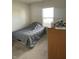 Cozy bedroom with carpeted floor and a gray comforter at 2708 W Kings Cyn Rd, Muncie, IN 47303