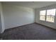 Spacious bedroom with neutral walls and carpet, featuring a large window at 3117 Lennon Ln, Indianapolis, IN 46235