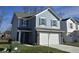 Two-story house with gray siding, white garage door, and landscaped lawn at 3117 Lennon Ln, Indianapolis, IN 46235