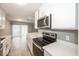 Bright kitchen boasts white cabinets, stainless steel range, and microwave at 3965 N Meridian St # Apt 2A, Indianapolis, IN 46208