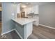 Modern kitchen with white cabinets and a large quartz countertop island at 3965 N Meridian St # Apt 2A, Indianapolis, IN 46208