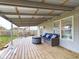 Relaxing covered back deck with seating area and fenced yard at 6024 Boulder Dr, Anderson, IN 46013