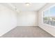 Spacious bedroom with neutral walls, gray carpet, and large window at 6415 Kelsey Dr, Indianapolis, IN 46268