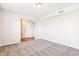 Bright bedroom with neutral walls, gray carpet, and access to hallway at 6415 Kelsey Dr, Indianapolis, IN 46268