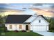 White farmhouse-style home with a two-car garage and landscaping at 6815 W Division Rd, Bargersville, IN 46106