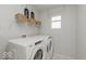 Laundry room with Whirlpool washer and dryer, and shelving at 6837 Bridle Oaks Ct, Whitestown, IN 46075