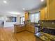 Kitchen with granite countertops, light wood cabinets, and a breakfast bar at 8265 Plumwood Ln, Indianapolis, IN 46256