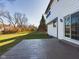 Stamped concrete patio, backyard view, large grassy area, and trees at 8265 Plumwood Ln, Indianapolis, IN 46256