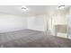 Upstairs hallway with grey carpeting and access to bedrooms at 8442 Burket Way, Camby, IN 46113