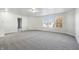 Bright living room with neutral carpeting and large windows at 8442 Burket Way, Camby, IN 46113