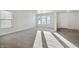 Open living room with carpeted floor and access to kitchen at 8442 Burket Way, Camby, IN 46113