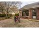 Brick patio with metal table and chairs, adjacent to home at 1055 Collingwood Dr, Indianapolis, IN 46228