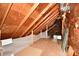 Unfinished attic space with plywood flooring and exposed beams at 1500 S Anderson St, Elwood, IN 46036