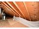 Unfinished attic space with plywood flooring and exposed beams at 1500 S Anderson St, Elwood, IN 46036