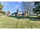 Spacious backyard with mature trees and large lawn at 1500 S Anderson St, Elwood, IN 46036
