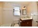 Clean bathroom with white tile and wood vanity at 1500 S Anderson St, Elwood, IN 46036