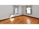 Hardwood floors and two windows in this bedroom at 1500 S Anderson St, Elwood, IN 46036