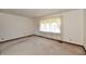 Bright bedroom with neutral carpeting and large window at 1500 S Anderson St, Elwood, IN 46036