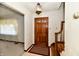 Entryway with wood staircase and stained glass door at 1500 S Anderson St, Elwood, IN 46036