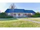 Brick ranch house with attached garage and landscaped yard at 1500 S Anderson St, Elwood, IN 46036