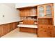 Retro kitchen boasts wood cabinets, a white countertop and a pass-through counter at 1500 S Anderson St, Elwood, IN 46036