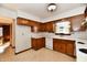 Retro kitchen features wood cabinets, white appliances, and a corner sink at 1500 S Anderson St, Elwood, IN 46036