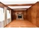 Bright living room featuring hardwood floors, wood paneling, and a brick fireplace at 1500 S Anderson St, Elwood, IN 46036