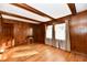 Living room with hardwood floors, wood paneling, and two windows at 1500 S Anderson St, Elwood, IN 46036