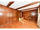 Sunlit living room with hardwood floors and wood paneling at 1500 S Anderson St, Elwood, IN 46036