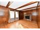 Living room with hardwood floors, wood paneling, fireplace, and large windows at 1500 S Anderson St, Elwood, IN 46036