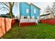 Home features a blue exterior, deck and fenced backyard at 2318 E Brookside Ave, Indianapolis, IN 46218