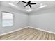 Bright bedroom with ceiling fan, large window and wood flooring at 2318 E Brookside Ave, Indianapolis, IN 46218