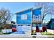 Stunning two-story blue house with a white garage door and landscaped lawn at 2318 E Brookside Ave, Indianapolis, IN 46218