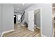 Bright foyer with wood-look floors, powder room, and elegant staircase at 2318 E Brookside Ave, Indianapolis, IN 46218