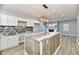 Modern kitchen with white cabinets, granite countertops, and a large island at 2318 E Brookside Ave, Indianapolis, IN 46218