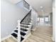 Elegant staircase with black spindles and white risers at 2318 E Brookside Ave, Indianapolis, IN 46218