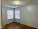 Bedroom with hardwood floors and two windows at 3206 W 57Th St, Indianapolis, IN 46228