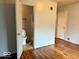 Bedroom with hardwood floors and en-suite bathroom at 3206 W 57Th St, Indianapolis, IN 46228