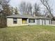 Ranch home with stone exterior, attached two-car garage, and landscaped lawn at 3206 W 57Th St, Indianapolis, IN 46228