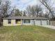 Ranch home with stone exterior, attached two-car garage, and landscaped lawn at 3206 W 57Th St, Indianapolis, IN 46228