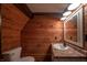 Bathroom with wood walls and a pedestal sink at 4298 W 300 N, Anderson, IN 46011