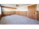 Cozy bedroom featuring wood wall paneling and carpet at 4298 W 300 N, Anderson, IN 46011