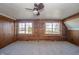 Spacious bedroom with log cabin walls and large windows at 4298 W 300 N, Anderson, IN 46011