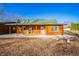Charming log cabin home with green roof and spacious covered porch at 4298 W 300 N, Anderson, IN 46011